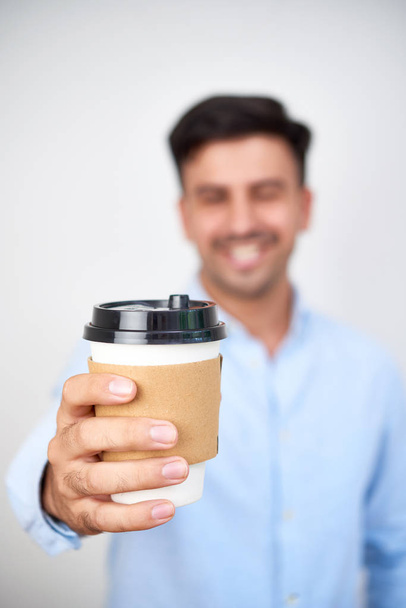 Close-up of man holding delicious hot coffee in paper cup - Fotoğraf, Görsel