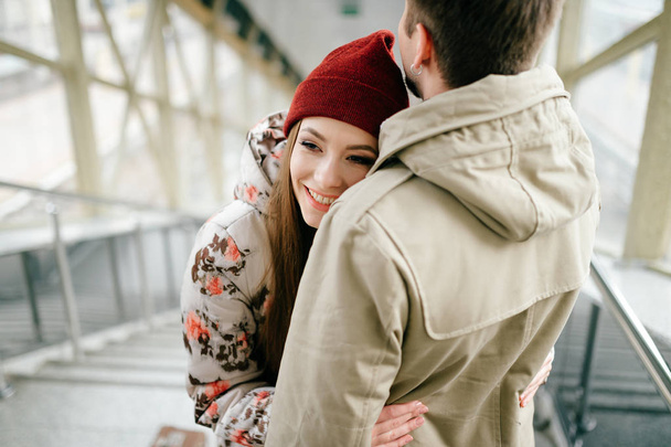romantic couple in love hugging while standing on stairs - Photo, image