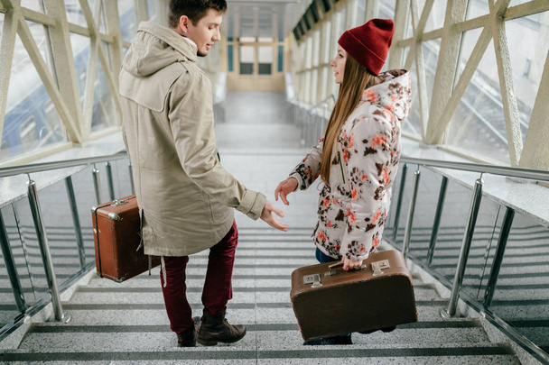 romantic couple in love with suitcases on stairs - Valokuva, kuva