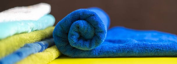 close up photo of rolled stack of colorful towels b - Photo, Image
