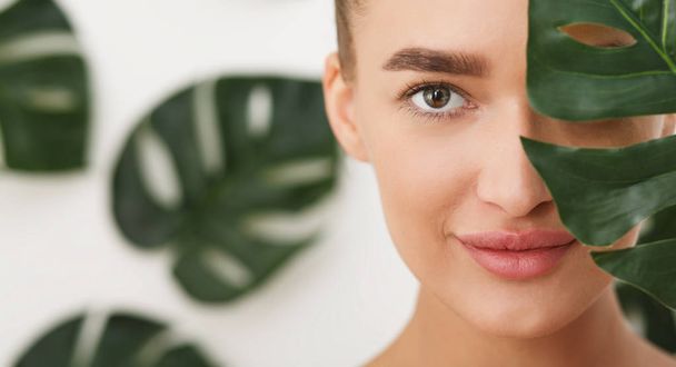 Woman with natural make up and green leaf - Photo, image