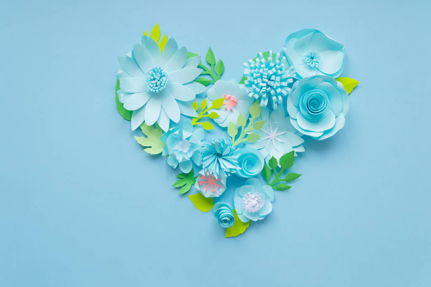 Heart from blue paper flowers with green leaves on blue background. Cut from paper. - Photo, Image