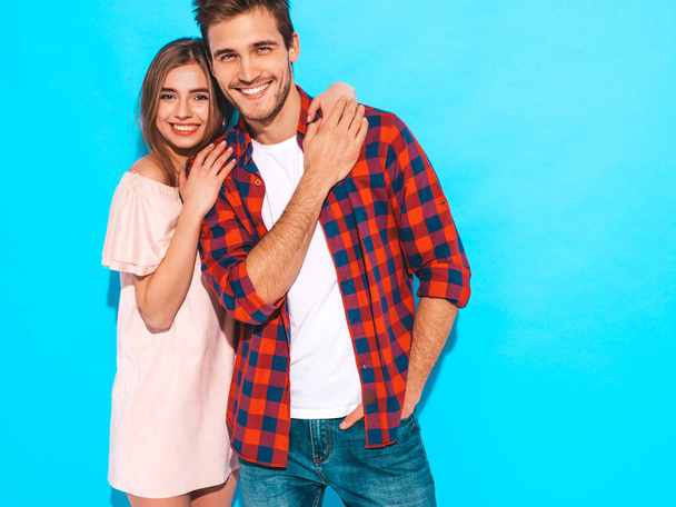 Smiling Beautiful Girl and her Handsome Boyfriend laughing.Happy Cheerful Family.Valentine's Day. Posing near blue wall. Hugging - Foto, Imagen
