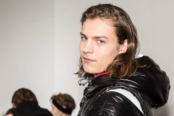 MILAN, ITALY - JANUARY 14: Beautiful model poses in the backstage just before Spyder show during Milan Men's Fashion Week on JANUARY 14, 2019 in Milan. - 写真・画像