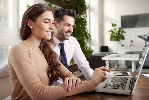 Shot of young businesswoman and professional financial assistant businessman working together on laptop while sitting in the office. Business meeting in the office.  - Foto, immagini