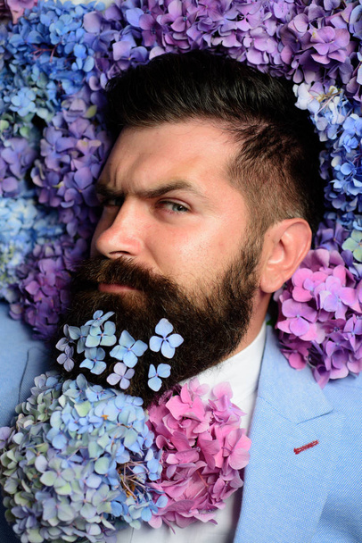 male with hydrangea flowers. brutal caucasian hipster with moustache. spring. womens day. Mature hipster with beard. Healthy hair and skin. Bearded man. Summer. Stylish and confident - 写真・画像