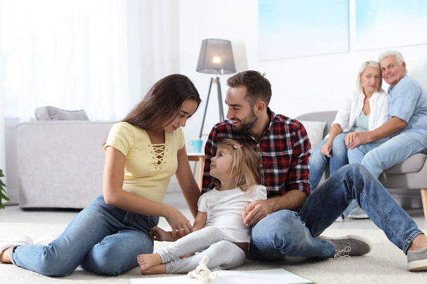 Young couple spending time with their daughter at home. Happy family - Fotoğraf, Görsel