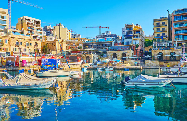 ST JULIANS, MALTA - JUNE 20, 2018: The popular tourist resort offers many place for rest and different attraction, here holidaymakers will find nice cafes, restaurants, fashion stores, malls and casinos, on June 20 in St Julians. - 写真・画像