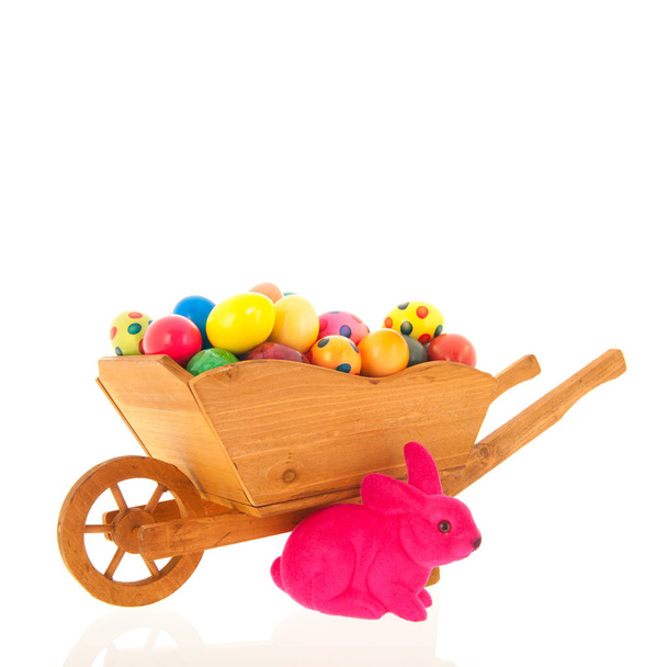 Wheelbarrow easter hare and eggs isolated over white background - Foto, Imagen