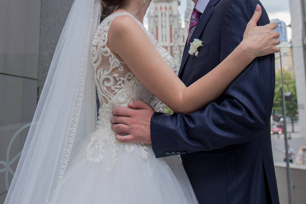 bride and groom stand together near the building - Zdjęcie, obraz