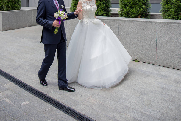 bride and groom are standing near the stairs - Photo, Image