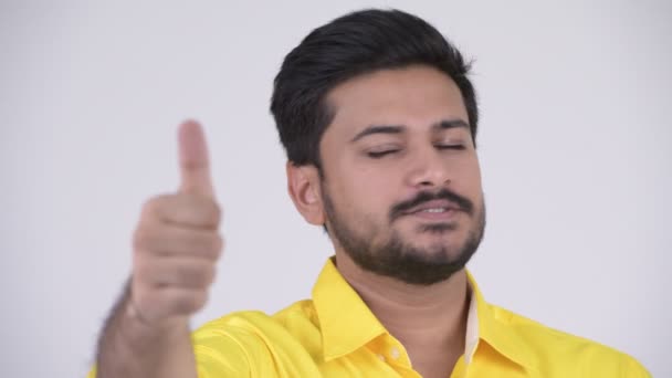 Young happy bearded Indian businessman giving thumbs up - Filmati, video