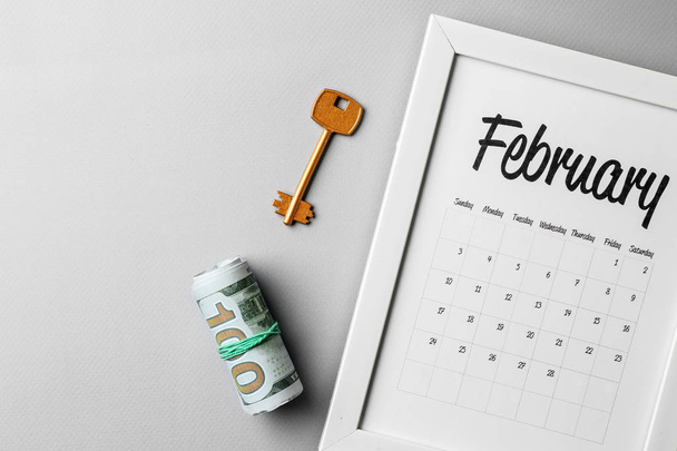Calendario, llave y dinero sobre fondo gris. Concepto hipotecario
 - Foto, Imagen