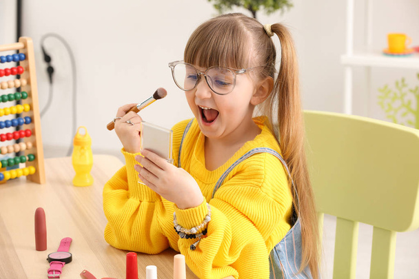 Cute little fashionista with cosmetics at home - Photo, Image