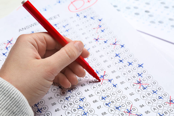 Teacher checking answer sheet after exam, closeup - Photo, Image