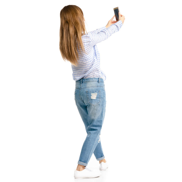 Woman in blue jeans and shirt smartphone selfie - Foto, afbeelding