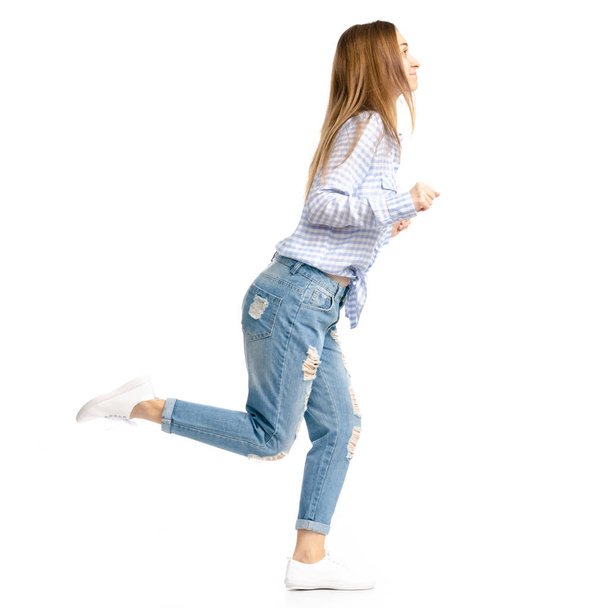 Woman in blue jeans and shirt goes run - Foto, immagini