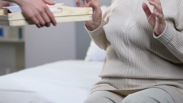 Naughty elderly female refusing to eat porridge in nursing home, untasty food - Filmati, video