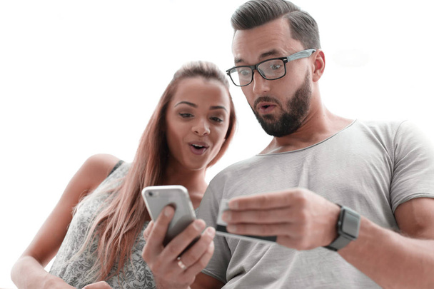 Young couple doing online shopping with smartphone - Photo, image