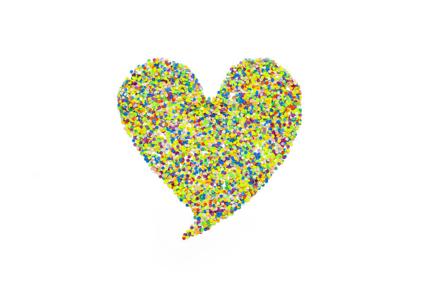 Heart made of colored confetti. Small circles of colored paper. White background. View from above. Colored heart. - Foto, immagini