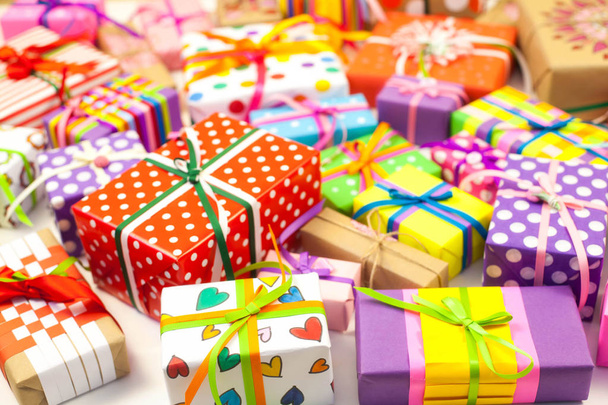 Colored gift boxes with colorful ribbons. Yellow background. Gifts for Christmas or a birthday. - Foto, Imagem