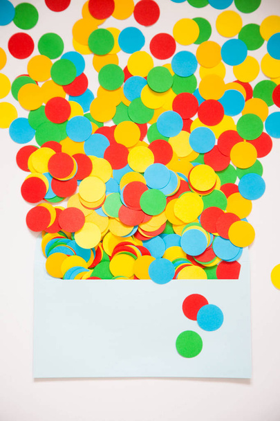 Confetti scattered in different colors on a white background. Festive confetti. The decor for the party. - Zdjęcie, obraz