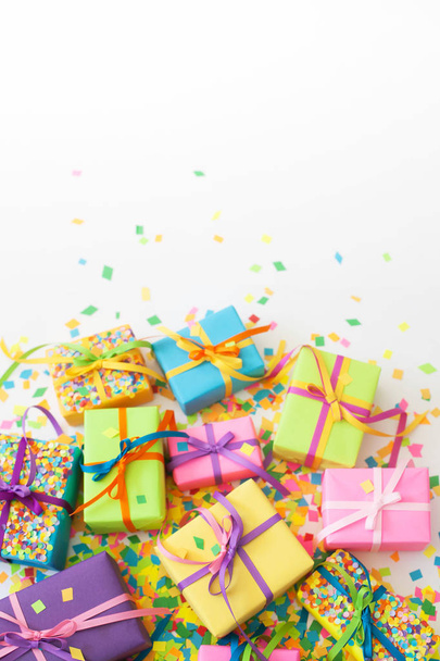 Colored gift boxes with colorful ribbons. White background. Gifts for Christmas or a birthday. - Foto, afbeelding