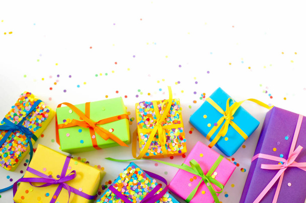 Colored gift boxes with colorful ribbons. White background. Gifts for Christmas or a birthday. - Фото, зображення