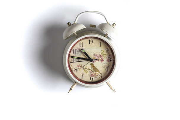 white retro alarm clock idolated on colorful background on wood surface b - Foto, Bild