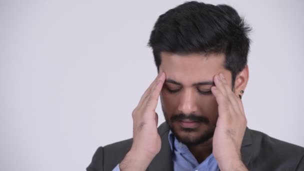 Young stressed bearded Indian businessman having headache - Footage, Video