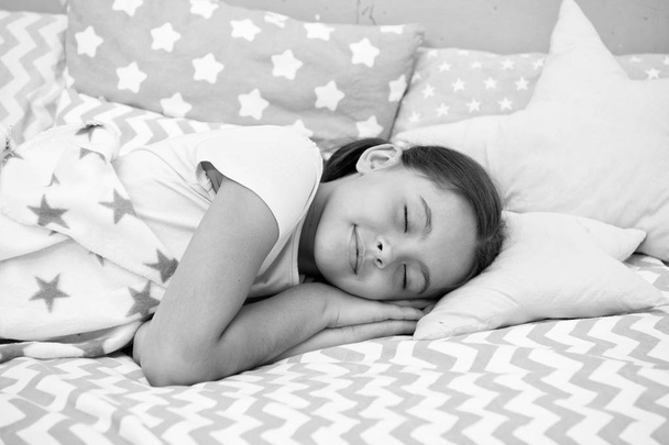 Girl child fall asleep on pillow. Quality of sleep depends on many factors. Choose proper pillow to sleep well. Girl lay on pillow bedclothes background. Child having nap. Cute badclothes and pillows - Photo, image