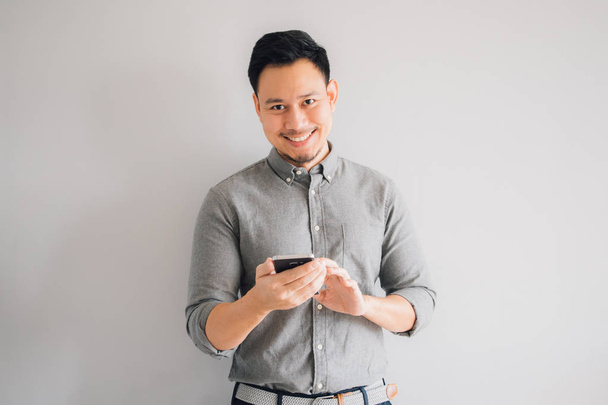 Happy smile face of handsome Asian man use smartphone. - 写真・画像