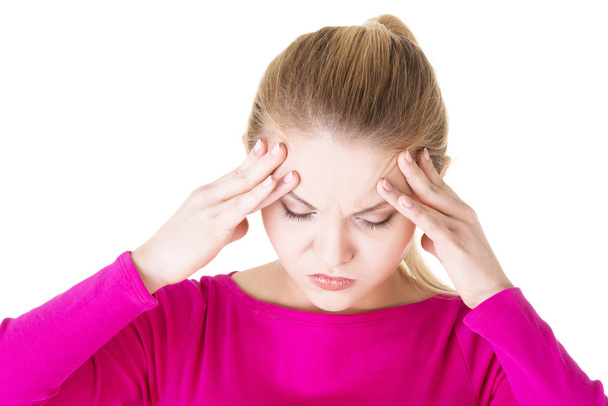 tiener vrouw met hoofdpijn - Foto, afbeelding