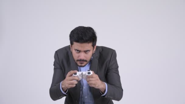 Young stressed bearded Indian businessman playing games and losing - Materiał filmowy, wideo