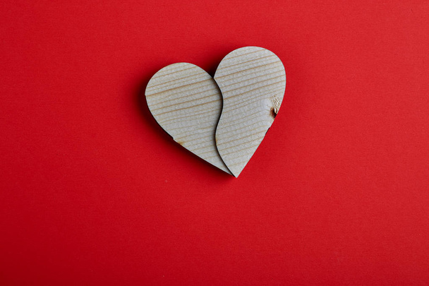 Valentine`s day Wooden heart shape on red paper background, 14th of February, Flat lay. View from above , Empty space for design - Foto, afbeelding