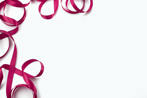 Koristeellinen runko vaaleanpunainen satiininauha valkoinen tausta. Top näkymä kopioi tilaa
 - Valokuva, kuva