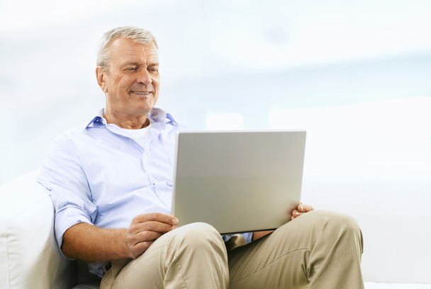 Smiling Senior Man On Couch - Фото, изображение