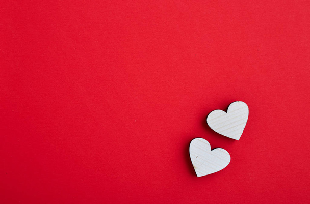 kırmızı arka planda aşık iki ahşap kalp çift. Sevgililer kalpleri kavramı. boş kopyalama alanı. mutlu sevgililer günü - 14 Şubat - Fotoğraf, Görsel