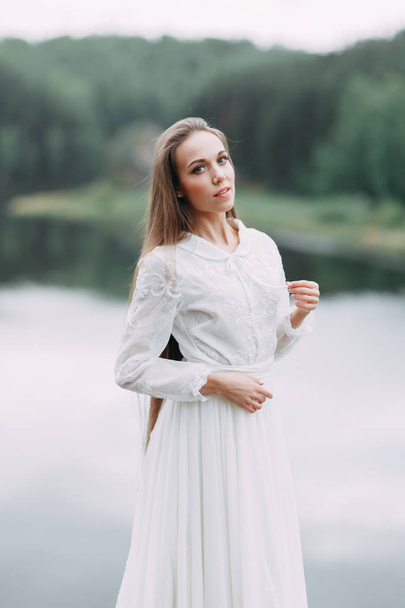 Morning bride on a beautiful panoramic location. Girl in boudoir dress and cliffs. - Valokuva, kuva