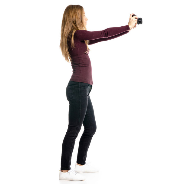 Woman in black jeans and shirt with camera in hand - Fotó, kép