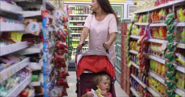Adult woman with kid shopping together - Footage, Video