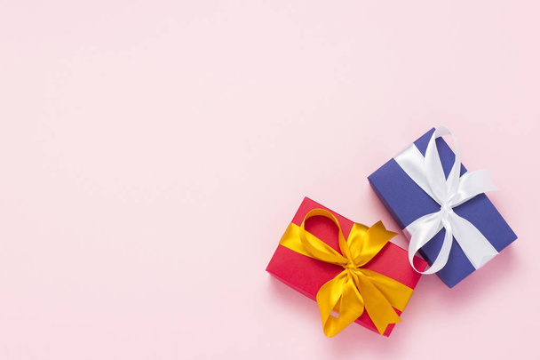 Two gift boxes on a pink background. Holiday concept, New Year, Christmas, Birthday, Valentine's Day. Flat lay, top view - 写真・画像