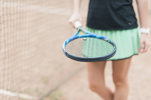 female tennis player holding tennis racket on clay court training - 写真・画像