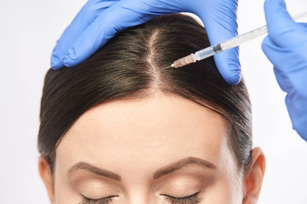 Face needle injection. Young woman cosmetology procedure. Doctor gloves. - Fotografie, Obrázek