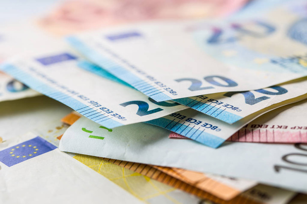 Euro banknotes in detail on the pile of other nominal banknotes. - Foto, imagen