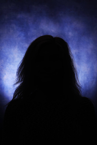 Silhouettes of a female head on a blue background - Fotografie, Obrázek