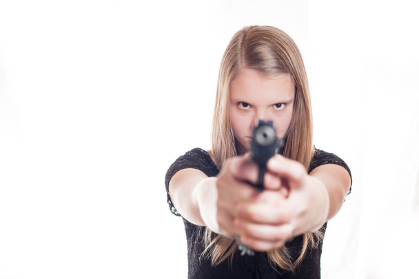 Blonde girl aiming with hand gun - Fotó, kép