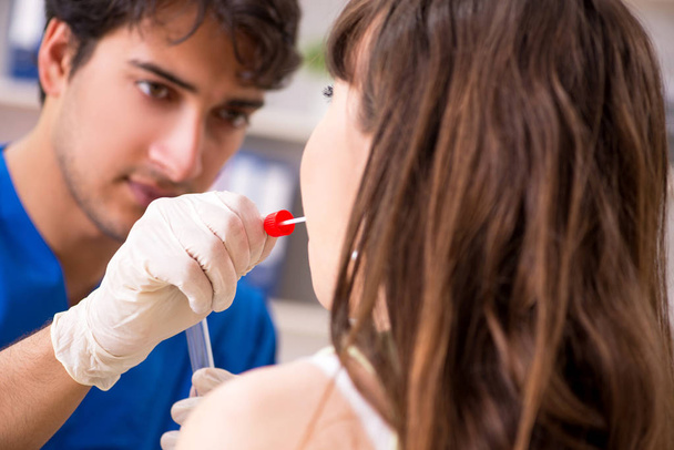 Doctor getting saliva test sample in clinic hospital - Foto, Imagen