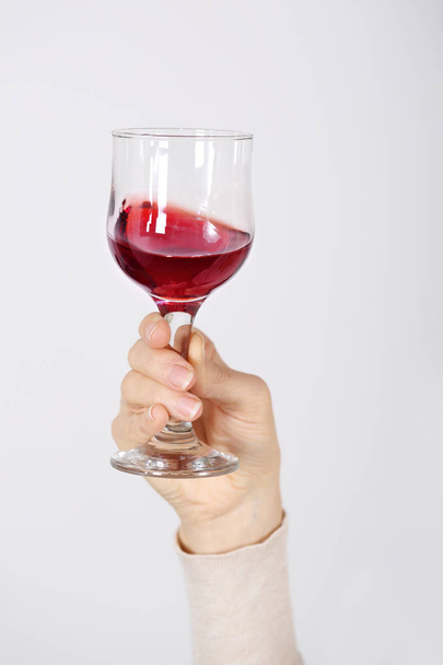 Un bicchiere di vino rosato in mano
 - Foto, immagini