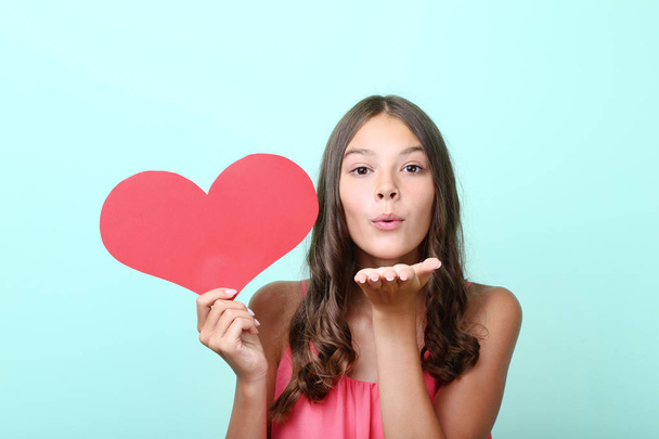 Young girl holding red paper heart and sending air kiss - Φωτογραφία, εικόνα